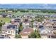 Scenic aerial view of a community, with homes featuring solar panels, mountains, and open land at 836 Sundance Ln, Erie, CO 80516