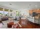 Open-concept living room featuring hardwood floors, bright windows, and modern decor at 836 Sundance Ln, Erie, CO 80516