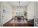 Office with hardwood floors, natural light, a modern light fixture and glass french doors at 836 Sundance Ln, Erie, CO 80516