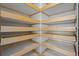 Walk-in closet features custom wooden shelving for optimized storage and organization at 836 Sundance Ln, Erie, CO 80516