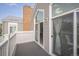 Balcony with brick chimney, sliding glass door and view of another balcony at 3331 S Monaco Pkwy # D, Denver, CO 80222
