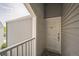 Balcony view of a white door with the letter D on gray siding at 3331 S Monaco Pkwy # D, Denver, CO 80222