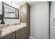 Bathroom featuring sink, cabinets, large mirror and in-unit washer and dryer at 3331 S Monaco Pkwy # D, Denver, CO 80222