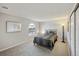 Bedroom features a cozy bed and a bright window and mirror on the wall at 3331 S Monaco Pkwy # D, Denver, CO 80222