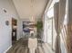 Bright dining area with a modern chandelier, scenic artwork, and sliding glass doors to the balcony, ideal for entertaining at 3331 S Monaco Pkwy # D, Denver, CO 80222