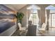 Dining area boasts elegant decor, a stylish chandelier, and balcony access, perfect for enjoying meals with a view at 3331 S Monaco Pkwy # D, Denver, CO 80222