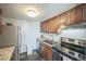 Kitchen featuring stainless steel appliances, granite counters, tile backsplash, and wood cabinets at 3331 S Monaco Pkwy # D, Denver, CO 80222