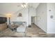 Spacious living room features vaulted ceiling, hardwood floors, grey sofa and access to other rooms at 3331 S Monaco Pkwy # D, Denver, CO 80222