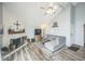Inviting living room with a modern fireplace, ceiling fan, and plush seating, creating a comfortable and stylish space at 3331 S Monaco Pkwy # D, Denver, CO 80222