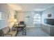 Well-lit home office features a desk, chair, storage cabinet, and window with natural light at 3331 S Monaco Pkwy # D, Denver, CO 80222