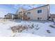 Back of house showing a deck, stairs, and a large concrete patio at 7033 S Waterloo Way, Aurora, CO 80016