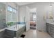 Spa-like bathroom with soaking tub, walk-in shower, and modern vanity at 7033 S Waterloo Way, Aurora, CO 80016
