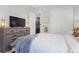 Guest bedroom with dresser and access to laundry at 7033 S Waterloo Way, Aurora, CO 80016