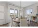 Bright dining room with a chandelier and access to a deck at 7033 S Waterloo Way, Aurora, CO 80016
