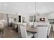 Open dining area with a round table and modern lighting at 7033 S Waterloo Way, Aurora, CO 80016