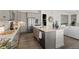 Modern kitchen with island, stainless steel appliances, and pantry at 7033 S Waterloo Way, Aurora, CO 80016