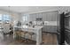 Modern kitchen with gray cabinets, an island, and stainless steel appliances at 7033 S Waterloo Way, Aurora, CO 80016