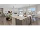 Open concept kitchen with island and views into the living room at 7033 S Waterloo Way, Aurora, CO 80016