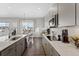 Modern kitchen with gray cabinets and quartz countertops at 7033 S Waterloo Way, Aurora, CO 80016