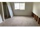 Carpeted bedroom with closet and window; some wall damage at 14141 E Jewell Ave # 102, Aurora, CO 80012