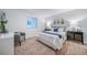 Neutral bedroom features a sitting chair and built in dresser at 3928 N Riviera Ct, Aurora, CO 80019