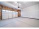 Empty two car garage featuring an automatic garage door and unfinished drywall at 3928 N Riviera Ct, Aurora, CO 80019