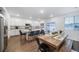 A kitchen and dining area featuring an island with seating and modern appliances, ideal for Gathering meals at 3928 N Riviera Ct, Aurora, CO 80019