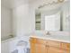 Bright bathroom features a bathtub, toilet, and sink vanity with a large mirror at 2660 S University Blvd # I, Denver, CO 80210