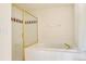 Clean bathroom with a shower and tub featuring gold trim and tiled walls at 2660 S University Blvd # I, Denver, CO 80210
