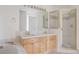 Bright bathroom with a double sink vanity, a separate shower, and a soaking tub at 2660 S University Blvd # I, Denver, CO 80210
