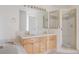 Bright bathroom features double sinks, a large mirror, and a glass-enclosed shower and soaking tub at 2660 S University Blvd # I, Denver, CO 80210