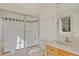 Bright bathroom featuring a shower over the tub and a simple vanity with a sink at 2660 S University Blvd # I, Denver, CO 80210
