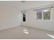 Spacious bedroom features two bright windows, neutral carpet, and white walls at 2660 S University Blvd # I, Denver, CO 80210