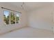 Bright bedroom with neutral carpet, white walls, large window, and modern lighting at 2660 S University Blvd # I, Denver, CO 80210