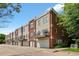 Townhome exterior with brick and siding, showcasing attached garages and upper level balconies at 2660 S University Blvd # I, Denver, CO 80210