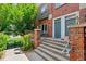 Charming brick townhome with a welcoming front entrance and manicured landscaping at 2660 S University Blvd # I, Denver, CO 80210