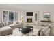Inviting living room with a fireplace, large windows, and a comfortable seating area at 2660 S University Blvd # I, Denver, CO 80210