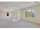 Spacious living room area featuring neutral carpet and an abundance of natural light at 2660 S University Blvd # I, Denver, CO 80210