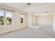 Bright and open living area with large windows and neutral carpet at 2660 S University Blvd # I, Denver, CO 80210
