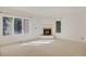Spacious and bright living room features a fireplace and large windows offering ample natural light at 2660 S University Blvd # I, Denver, CO 80210