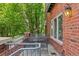 Cozy outdoor patio features a metal table and chairs with mature trees for shade at 2660 S University Blvd # I, Denver, CO 80210