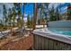 Secluded backyard with hot tub, seating around a firepit, and a private wooded area at 89 Fairview Cir, Breckenridge, CO 80424