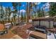 Secluded backyard with hot tub, a fire pit, a wood fence, and a private wooded area at 89 Fairview Cir, Breckenridge, CO 80424