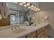 Bright bathroom with double sink vanity, granite counters, modern lighting and neutral paint at 89 Fairview Cir, Breckenridge, CO 80424