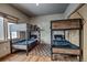 Bedroom with two bunkbeds, wood floor, area rug and window providing natural light at 89 Fairview Cir, Breckenridge, CO 80424
