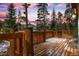 Relaxing wooden deck featuring wood railings and a charming exterior view of surrounding trees at 89 Fairview Cir, Breckenridge, CO 80424