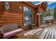 Inviting home deck with wicker chair, space for entertaining, and classic wood exterior at 89 Fairview Cir, Breckenridge, CO 80424