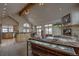 Open-concept living room with vaulted ceilings, a stone fireplace, and abundant natural light from large windows at 89 Fairview Cir, Breckenridge, CO 80424