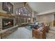 Inviting living room with stone fireplace and large windows showcasing natural light and beautiful outdoor views at 89 Fairview Cir, Breckenridge, CO 80424