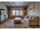 Bright living room with wood floors, media console and comfortable seating area and large window at 89 Fairview Cir, Breckenridge, CO 80424